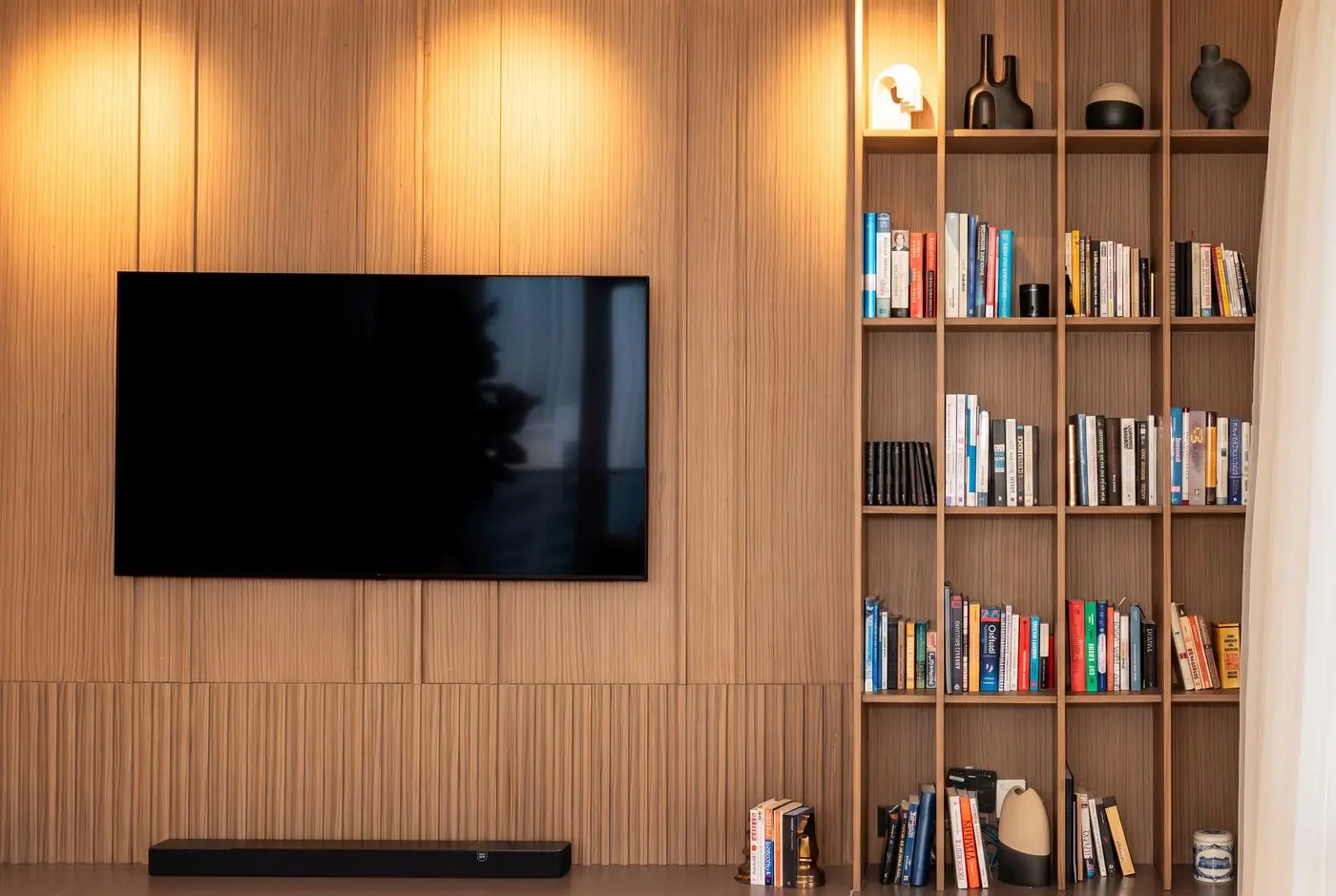 Media wall with integrated bookshelf
